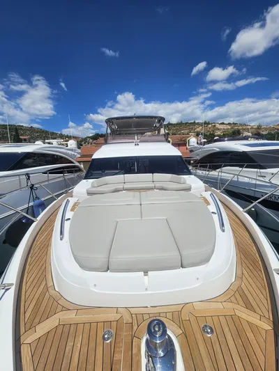  Yacht Photos Pics Luxury 2020 Princess F62 yacht with spacious deck and sleek design under clear blue sky.