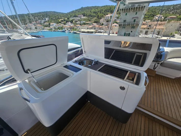  Yacht Photos Pics Outdoor kitchen on 2020 Princess F62 yacht with scenic harbor view.