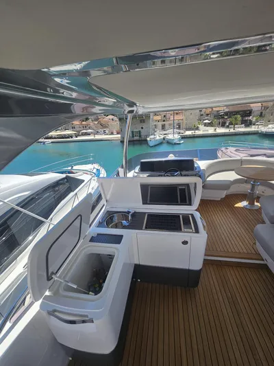  Yacht Photos Pics Luxurious 2020 Princess F62 yacht deck with kitchenette and stunning marina view.