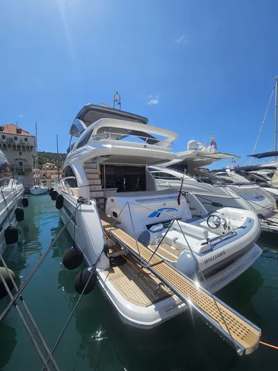  Yacht Photos Pics Luxurious 2020 Princess F62 yacht docked in a sunny marina.