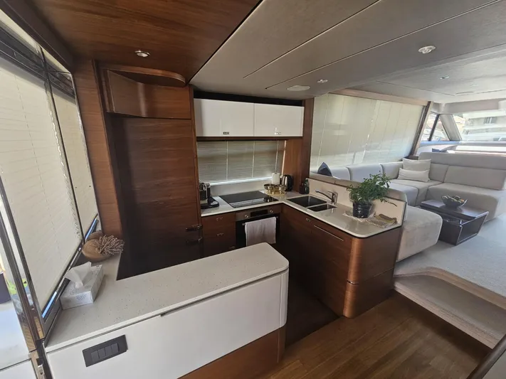  Yacht Photos Pics Luxurious interior of 2020 Princess F62 yacht with modern kitchen and seating area.
