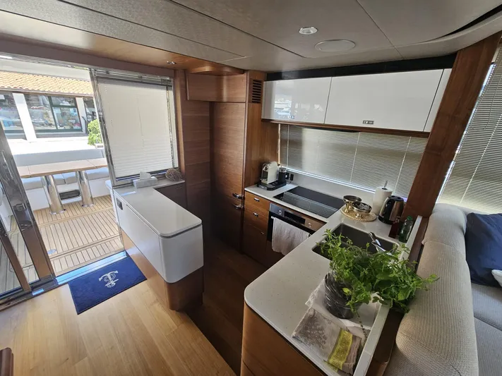  Yacht Photos Pics Luxurious 2020 Princess F62 yacht kitchen with modern appliances and elegant wood finishes.