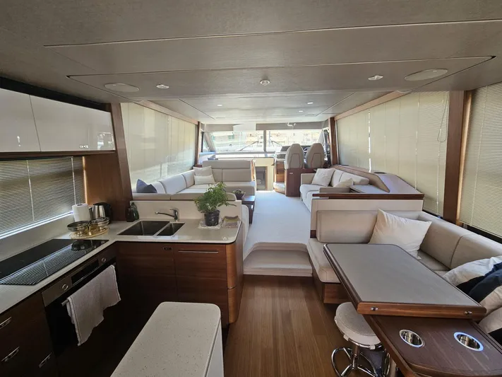  Yacht Photos Pics Luxurious interior of 2020 Princess F62 yacht with modern kitchen and seating area.