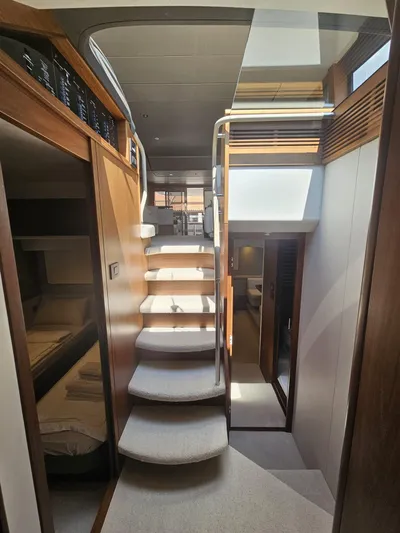  Yacht Photos Pics Interior of 2020 Princess F62 yacht, featuring elegant staircase and modern design elements.