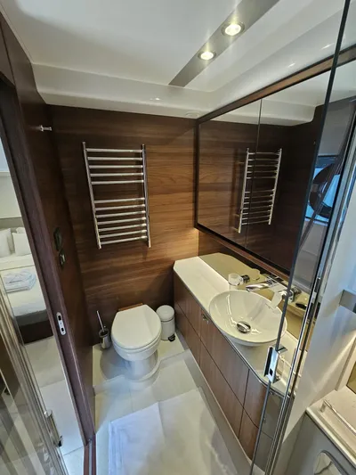  Yacht Photos Pics Luxurious bathroom in 2020 Princess F62 yacht with modern fixtures and wood accents.