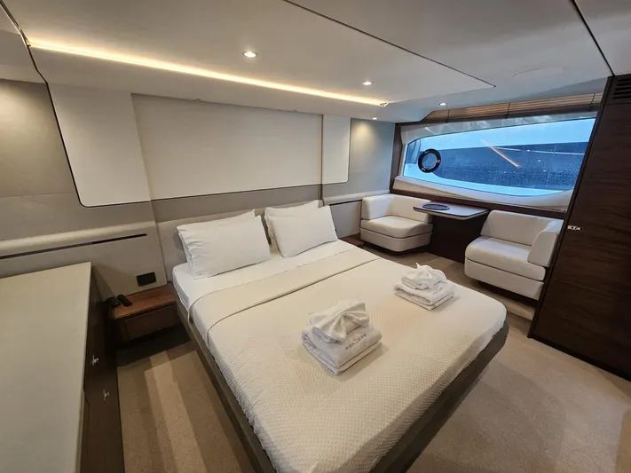  Yacht Photos Pics Luxurious cabin interior of 2020 Princess F62 yacht with modern furnishings and large window.