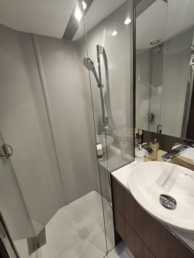  Yacht Photos Pics Modern bathroom in 2020 Princess F62 yacht with glass shower and sleek sink.