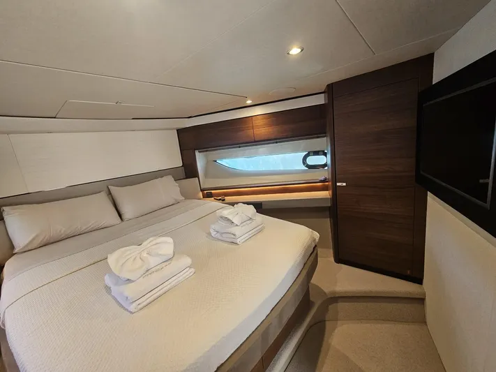  Yacht Photos Pics Luxurious bedroom interior of 2020 Princess F62 yacht with elegant bedding and modern design.