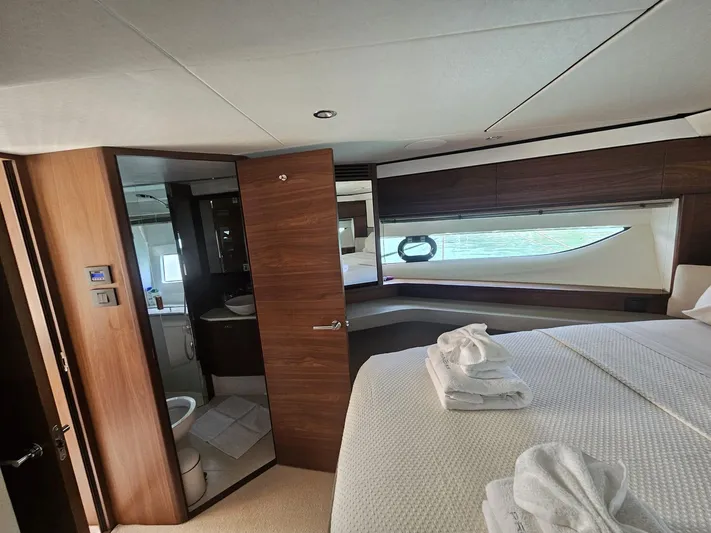  Yacht Photos Pics Luxurious 2020 Princess F62 yacht bedroom with ensuite bathroom and elegant wood finishes.