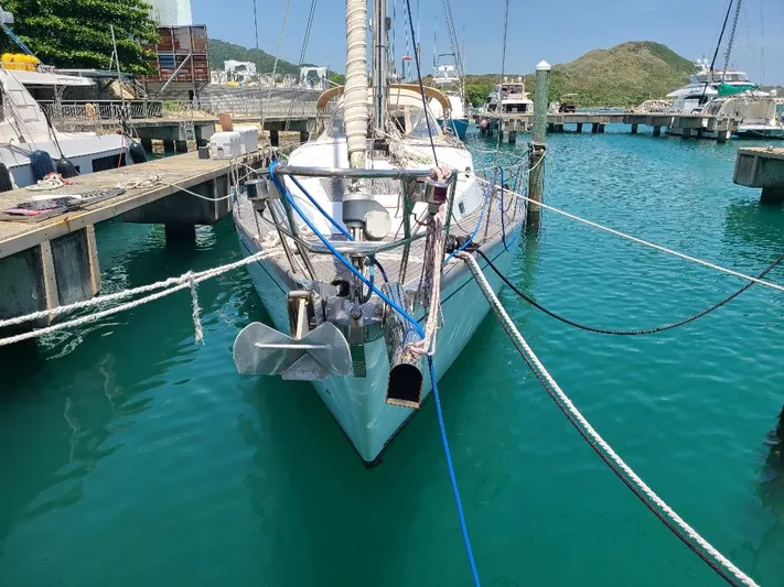Taita I Yacht Photos Pics Sailboat Comet 54 DH 2001 docked in a marina with clear turquoise water.