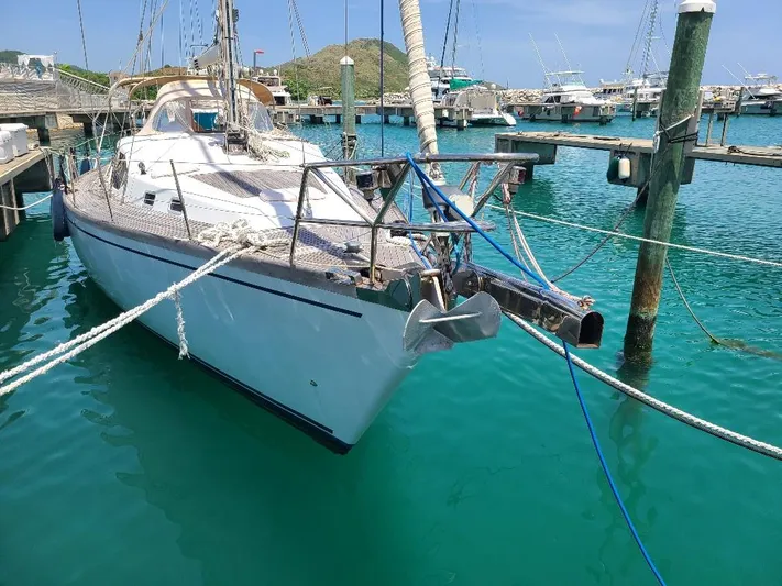 Taita I Yacht Photos Pics Sailboat Comet 54 DH 2001 docked in a marina with turquoise water.