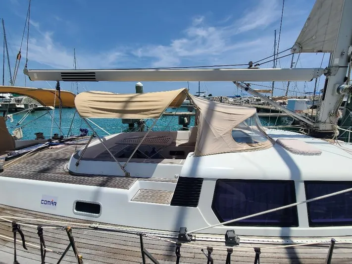 Taita I Yacht Photos Pics Sailboat Comet 54 DH, 2001 model, docked in a marina with clear blue water.