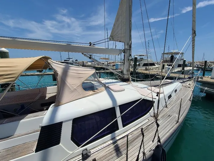 Taita I Yacht Photos Pics Sailboat Comet 54 DH, 2001 model, docked at marina under clear blue sky.