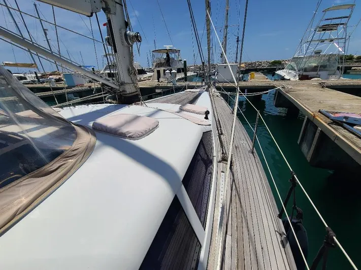 Taita I Yacht Photos Pics Sailboat Comet 54 DH, 2001 model, docked at marina with clear blue sky.