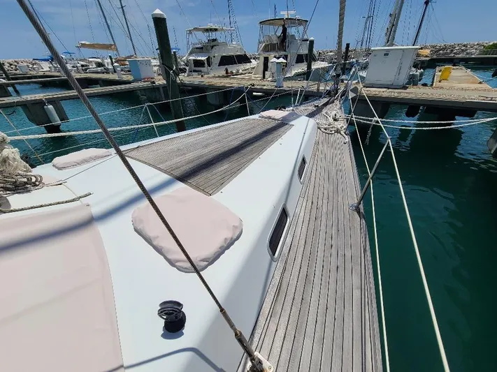Taita I Yacht Photos Pics Sailboat Comet 54 DH, 2001 model, docked at marina with clear blue water.