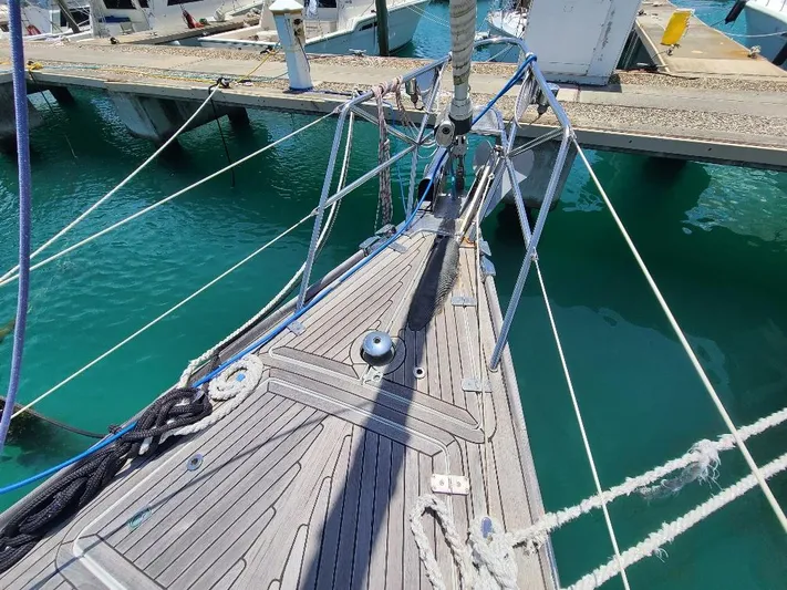 Taita I Yacht Photos Pics Bow of 2001 Comet 54 DH yacht docked at marina, featuring teak deck and rigging.