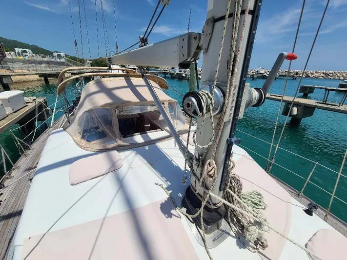Taita I Yacht Photos Pics Sailboat Comet 54 DH, 2001 model, docked at marina with clear blue water.