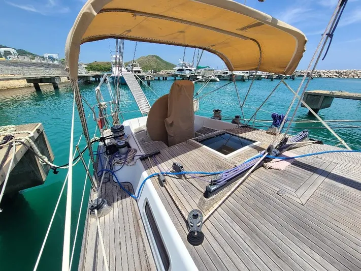 Taita I Yacht Photos Pics Sailboat Comet 54 DH 2001 docked at marina with clear blue water.