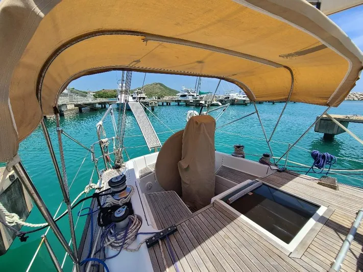 Taita I Yacht Photos Pics Sailboat deck view, Comet 54 DH, 2001 model, docked in a marina with turquoise water.
