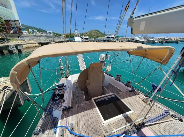 Taita I Yacht Photos Pics Sailboat Comet 54 DH, 2001 model, docked in a marina with turquoise water.