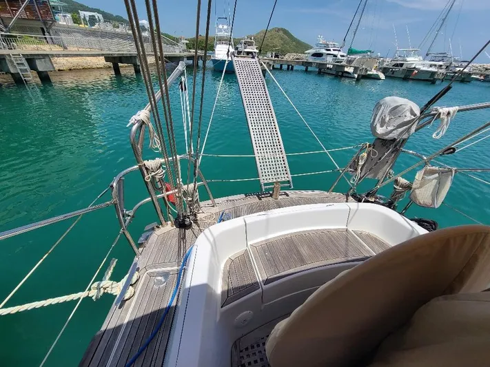 Taita I Yacht Photos Pics Sailboat docked in marina, Comet 54 DH, 2001 model, clear turquoise water.