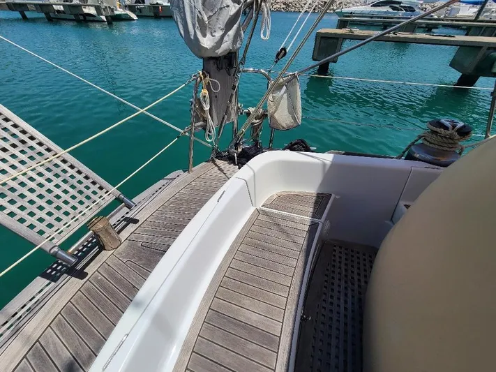 Taita I Yacht Photos Pics Sailboat deck of 2001 Comet 54 DH, docked in a marina with clear blue water.