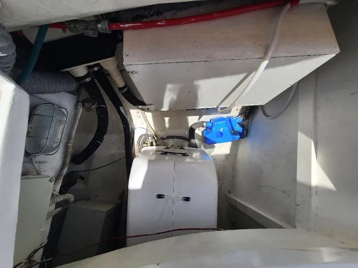 Taita I Yacht Photos Pics Engine compartment of a 2001 Comet 54 DH boat, showing mechanical components and wiring.