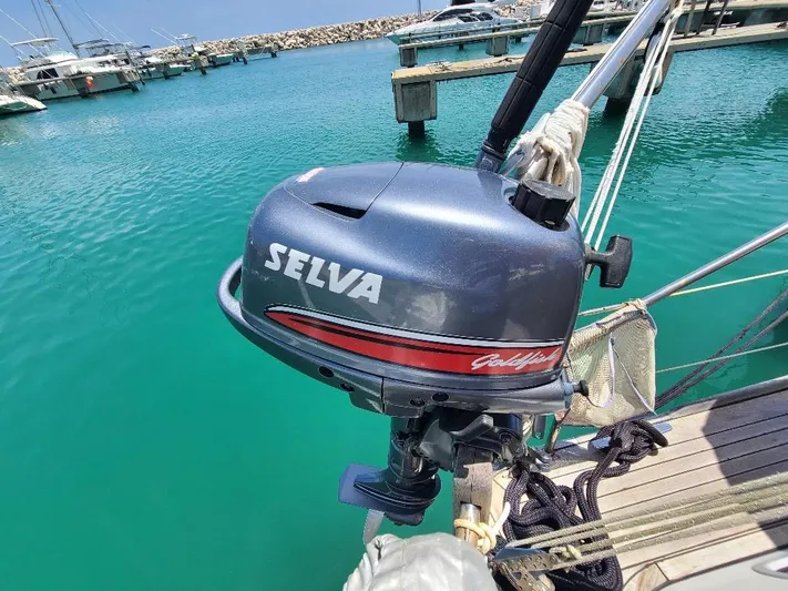 Taita I Yacht Photos Pics Outboard motor on a 2001 Comet 54 DH sailboat docked in a marina.