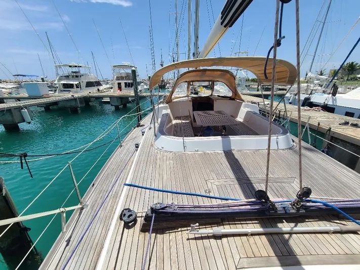 Taita I Yacht Photos Pics Sailboat Comet 54 DH, 2001 model, docked at marina with clear blue water.
