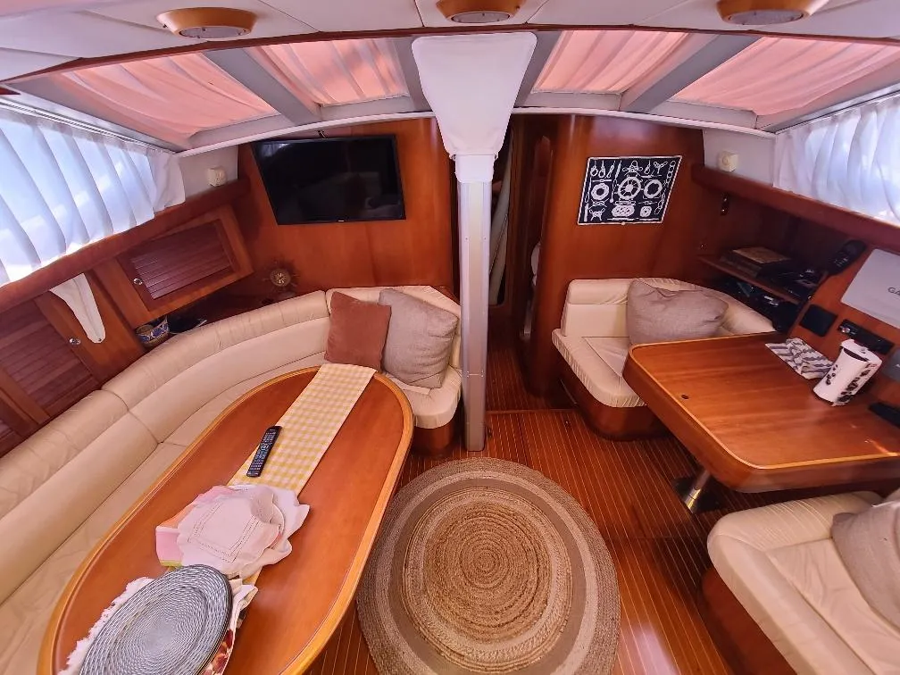 Luxurious interior of 2001 Comet 54 DH yacht with elegant wood finish and cozy seating.