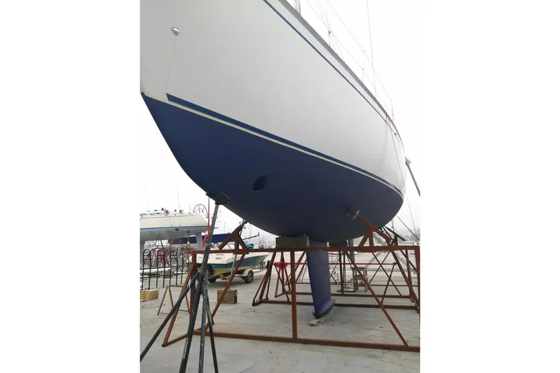 Taita I Yacht Photos Pics 2001 Comet 54 DH sailboat on dry dock, blue hull, supported by stands.