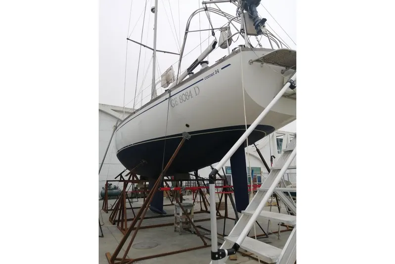 Taita I Yacht Photos Pics Sailboat Comet 54 DH, 2001 model, on dry dock with visible ladder and supports.