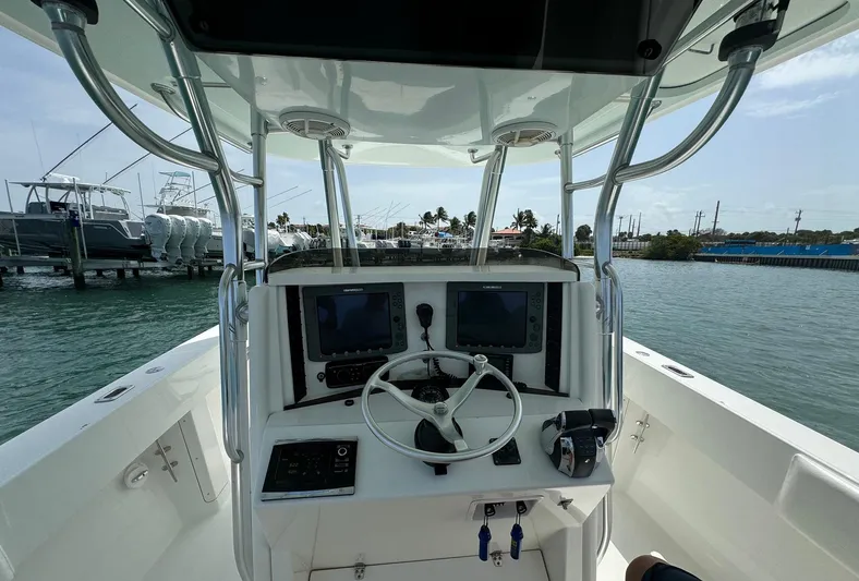 Reel Lucky Yacht Photos Pics 2006 Venture 34 Open boat helm with dual screens and steering wheel on water.