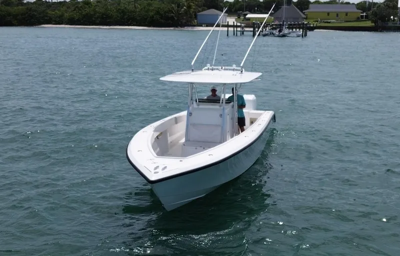 Reel Lucky Yacht Photos Pics 2006 Venture 34 Open boat cruising on calm waters near a dock.