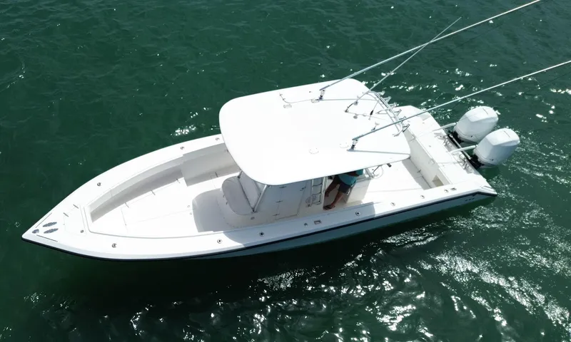 Reel Lucky Yacht Photos Pics 2006 Venture 34 Open boat on water, aerial view, white hull, dual engines.