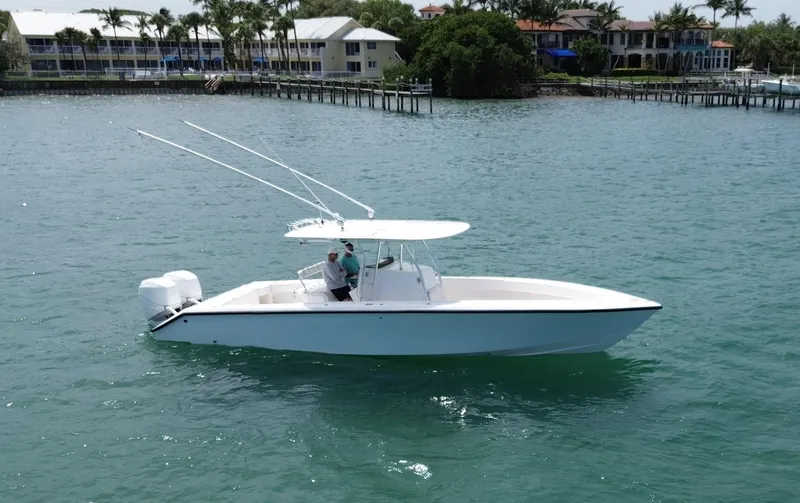 Reel Lucky Yacht Photos Pics 2006 Venture 34 Open boat cruising on a sunny day near waterfront homes.