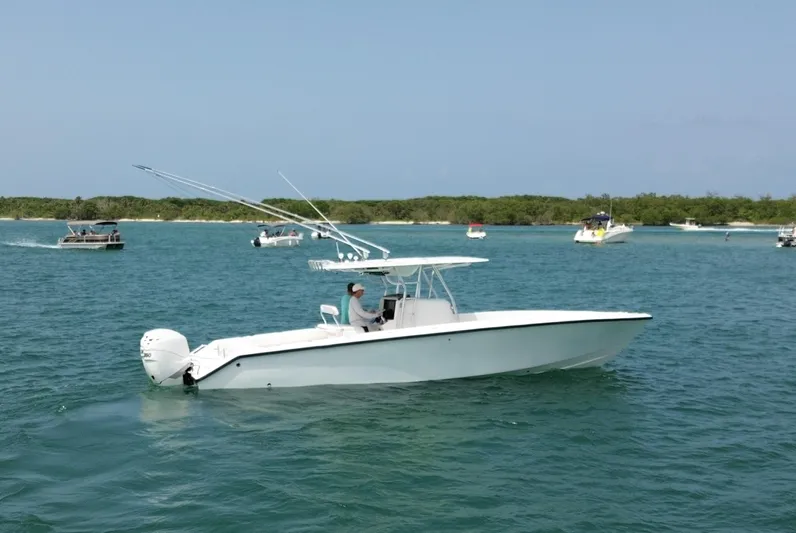 Reel Lucky Yacht Photos Pics 2006 Venture 34 Open boat cruising on a sunny day in clear waters.