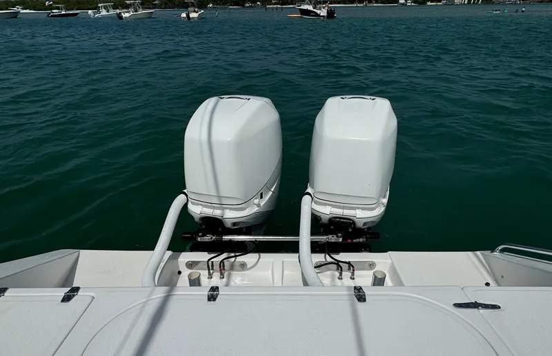 Reel Lucky Yacht Photos Pics Twin outboard motors on a 2006 Venture 34 Open boat in open water.
