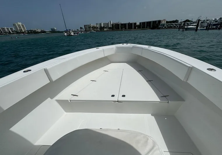 Reel Lucky Yacht Photos Pics 2006 Venture 34 Open boat deck with ocean and coastal buildings in the background.