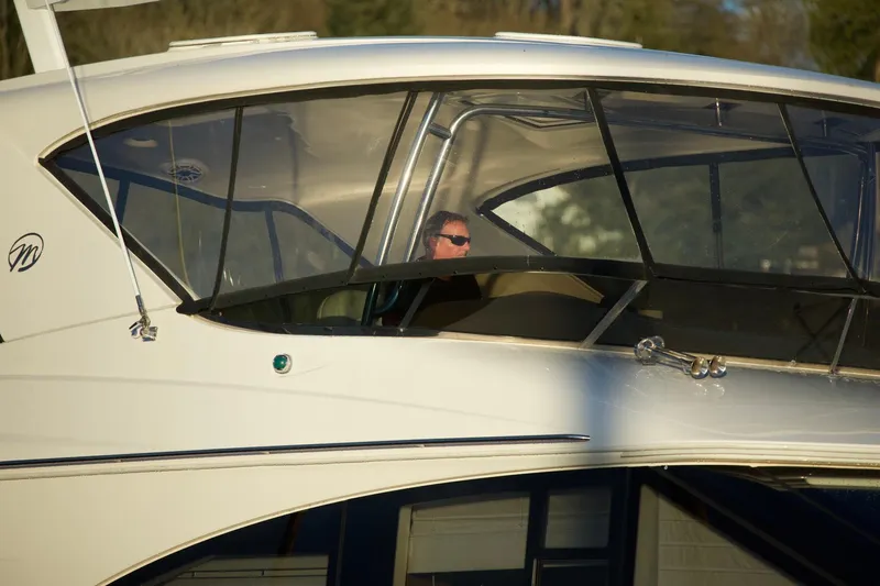  Yacht Photos Pics 2012 Meridian 541 Sedan yacht with person at helm, side view.