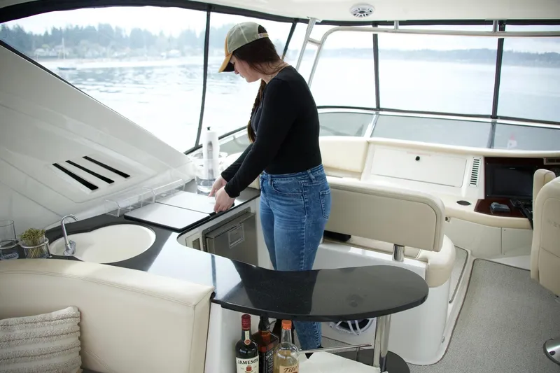  Yacht Photos Pics Woman in casual attire on 2012 Meridian 541 Sedan yacht interior.