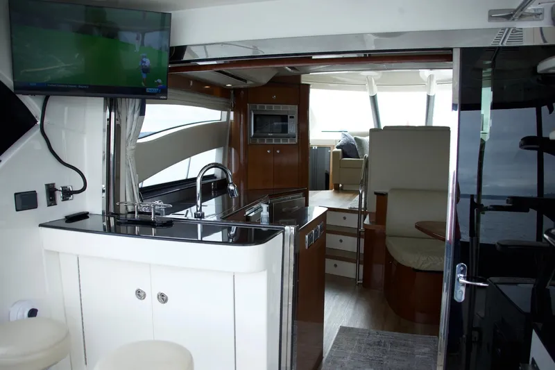  Yacht Photos Pics Interior of a 2012 Meridian 541 Sedan yacht with modern kitchen and seating area.