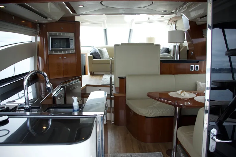  Yacht Photos Pics Luxurious interior of 2012 Meridian 541 Sedan yacht with modern kitchen and seating area.