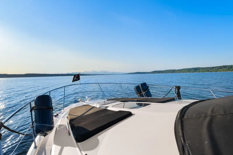 Yacht Photos Pics 2012 Meridian 541 Sedan yacht cruising on a serene blue lake under a clear sky.