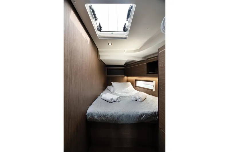  Yacht Photos Pics Cozy cabin interior of 2020 Beneteau Oceanis 46.1 yacht with skylight and bed.