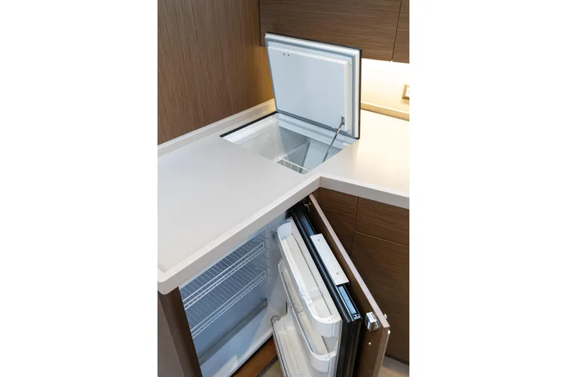  Yacht Photos Pics Modern kitchen area in 2020 Beneteau Oceanis 46.1 yacht with open fridge and freezer.
