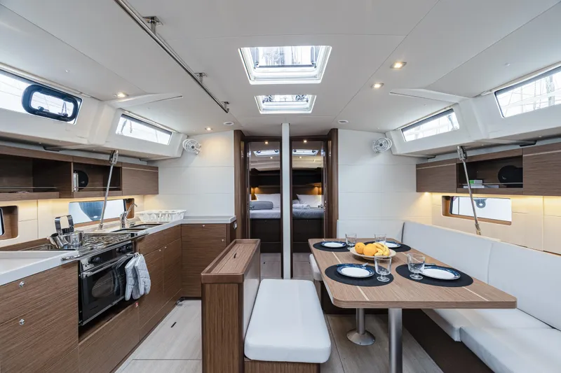  Yacht Photos Pics Luxurious interior of 2020 Beneteau Oceanis 46.1 yacht with modern kitchen and dining area.