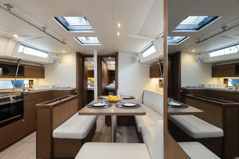  Yacht Photos Pics Luxurious interior of 2020 Beneteau Oceanis 46.1 yacht with modern dining area.