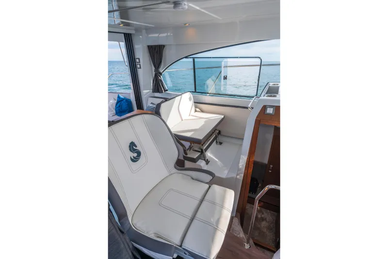  Yacht Photos Pics Interior of 2025 Beneteau Antares 11 Fly, featuring elegant seating and ocean view.