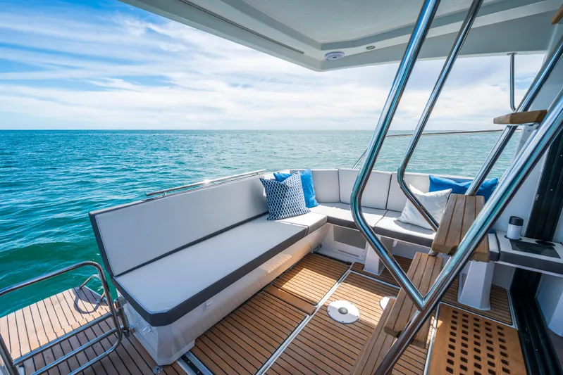  Yacht Photos Pics 2025 Beneteau Antares 11 Fly yacht deck with ocean view and comfortable seating.